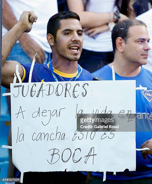 Boca Juniors shows a sign demanding players to play for their lives during a match between Boca Juniors and Estudiantes as part of forth round of...