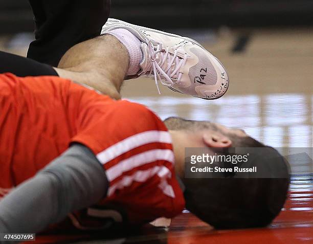 Stretching before the game Toronto Raptors point guard Greivis Vasquez's shoe reads "Paz" and "Venezuela quiere paz" as his country has been...