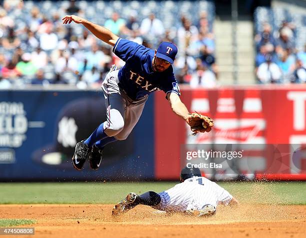 Brett Gardner of the New York Yankees steals second as Adam Rosales of the Texas Rangers defends in the first inning on May 23, 2015 at Yankee...