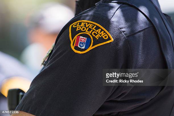 Cleveland police officer looks on as people take to the streets and protest in reaction to Cleveland police officer Michael Brelo being acquitted of...