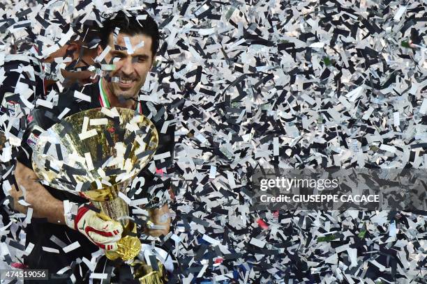 Juventus' goalkeeper and captain Gianluigi Buffon celebrates with the Italian League's trophy during a ceremony following the Italian Serie A...