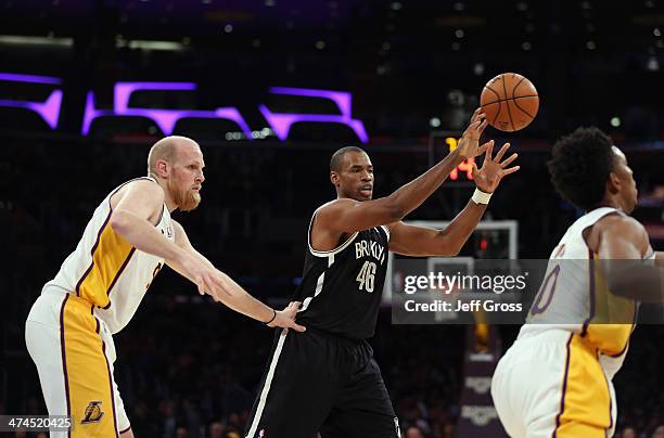 Jason Collins of the Brooklyn Nets is defended by Chris Kaman of the Los Angeles Lakers in the first half at Staples Center on February 23, 2014 in...