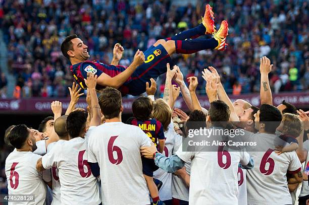 Xavi Hernandez of FC Barcelona is tosed by his teammates after the La Liga match between FC Barcelona and RC Deportivo La Coruna at Camp Nou on May...