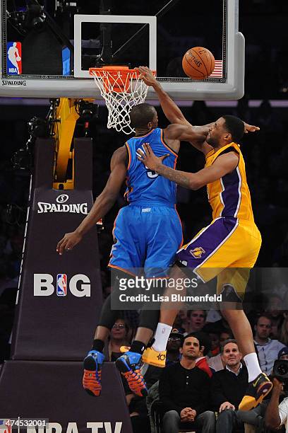 Shawne Williams of the Los Angeles Lakers puts a shot up against Serge Ibaka of the Oklahoma City Thunder at Staples Center on February 13, 2014 in...