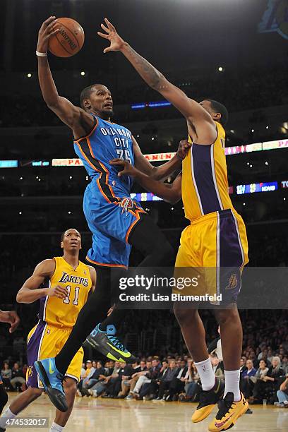 Kevin Durant of the Oklahoma City Thunder drives to the basket against Shawne Williams of the Los Angeles Lakers at Staples Center on February 13,...