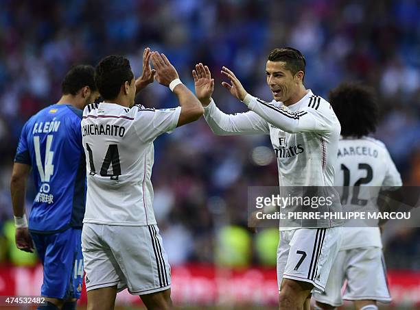 Real Madrid's Portuguese forward Cristiano Ronaldo celebrates with Real Madrid's Mexican forward Javier Hernandez after scoring during the Spanish...