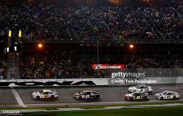 Dale Earnhardt Jr., driver of the National Guard Chevrolet, races ot the checkered flag to win the NASCAR Sprint Cup Series Daytona 500 at Daytona...