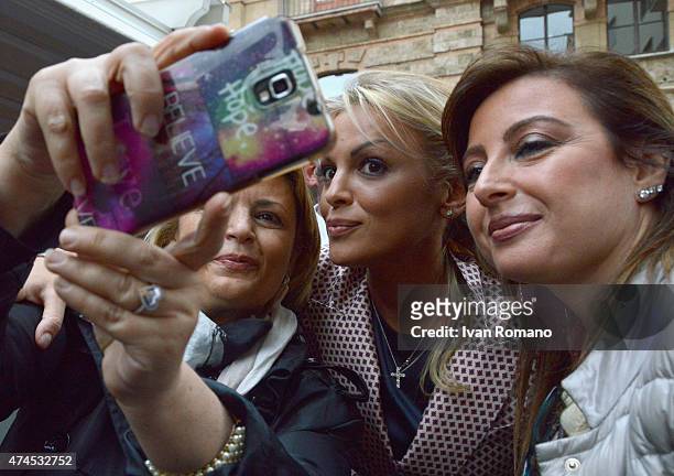 Francesca Pascale, girlfriend of Forza Italia president Silvio Berlusconi, takes photos with supporters during a visit with Berlusconi in support of...