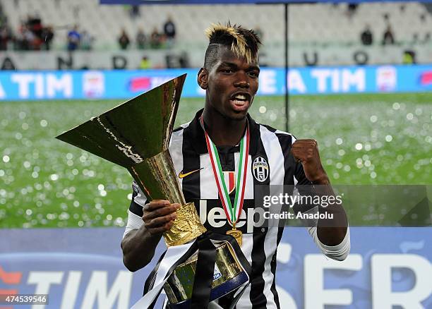 Juventus' midfielder from France Paul Pogba celebrates with the Italian League's trophy during a ceremony following the Italian Serie A football...