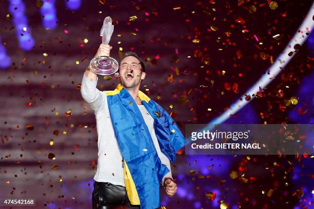 Sweden's Mans Zelmerlow celebrates with the trophy winning the 60th Eurovision Song Contest final on May 23, 2015 in Vienna. AFP PHOTO / DIETER NAGL