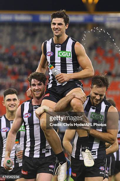Scott Pendlebury of the Magpies is chaired from the field after his 200th game during the round eight AFL match between the Gold Coast Suns and the...