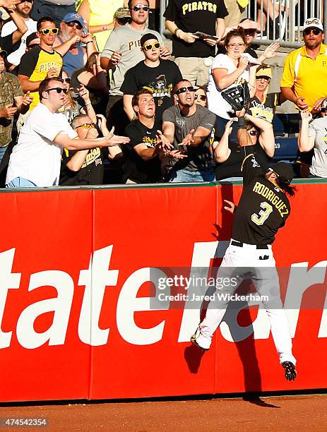 Sean Rodriguez of the Pittsburgh Pirates attempts to catch a home run hit by Ruben Tejada of the New York Mets in the 8th inning during the game at...