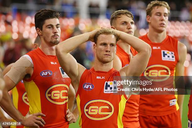 Brandon Matera and the Suns look dejected after losing during the round eight AFL match between the Gold Coast Suns and the Collingwood Magpies at...