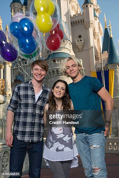 In this handout photo provided by Disney Parks, Disney Channel's 'Austin and Ally' stars Calum Worthy, Laura Marano and Ross Lynch pose in front of...
