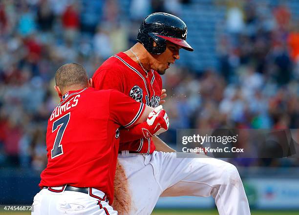 Jonny Gomes tackles Jace Peterson of the Atlanta Braves after he hit a walk-off RBI single in the 11th inning against the Milwaukee Brewers at Turner...