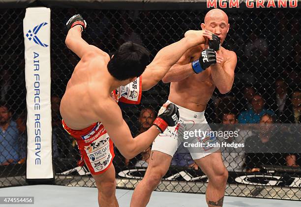 Dong Hyun Kim kicks Josh Burkman in their welterweight bout during the UFC 187 event at the MGM Grand Garden Arena on May 23, 2015 in Las Vegas,...