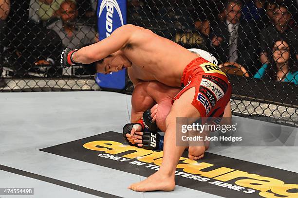 Dong Hyun Kim punches Josh Burkman in their welterweight bout during the UFC 187 event at the MGM Grand Garden Arena on May 23, 2015 in Las Vegas,...