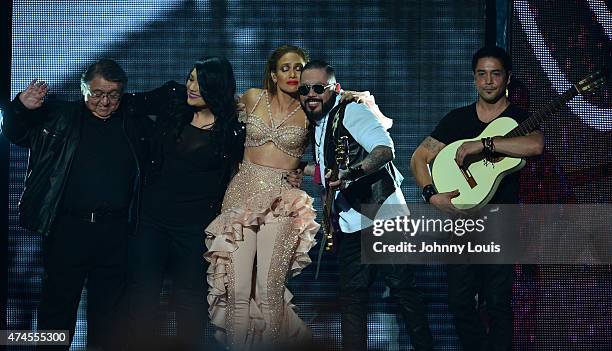 Jennifer Lopez performs musical tribute to Selena while performing with Los Dinos onstage at the 2015 Billboard Latin Music Awards presented by State...