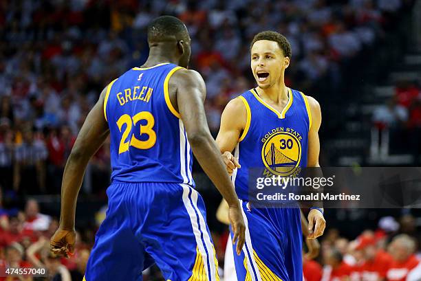 Stephen Curry of the Golden State Warriors celebrates with Draymond Green after setting the record for most three pointers in a post season in the...