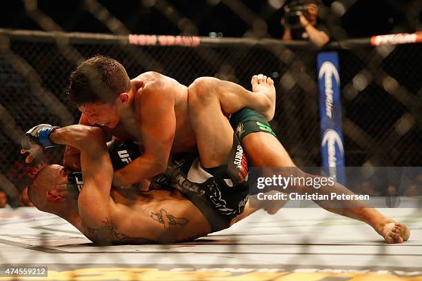 Joseph Benavidez elbows John Moraga in their flyweight bout during the UFC 187 event at the MGM Grand Garden Arena on May 23, 2015 in Las Vegas,...