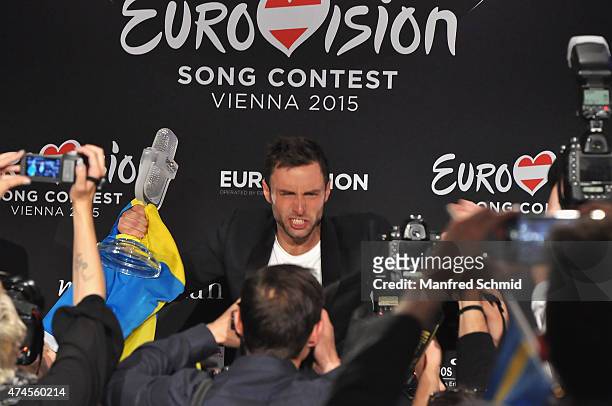 Mans Zelmerlow of Sweden holds the throphy during the press conference after winning the Eurovision Song Contest final on May 23, 2015.