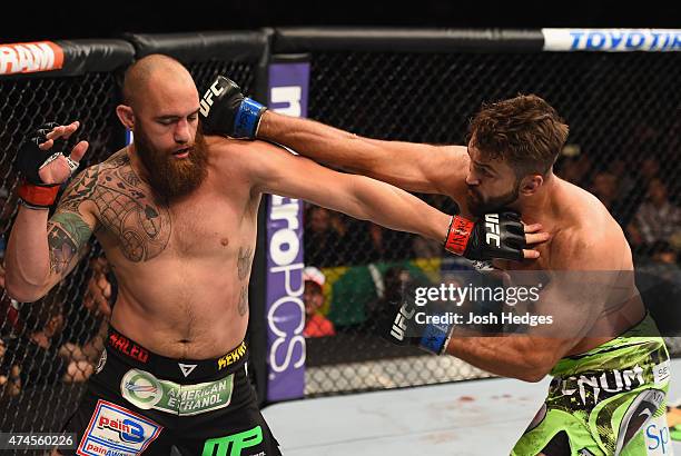 Andrei Arlovski punches Travis Browne in their heavyweight bout during the UFC 187 event at the MGM Grand Garden Arena on May 23, 2015 in Las Vegas,...