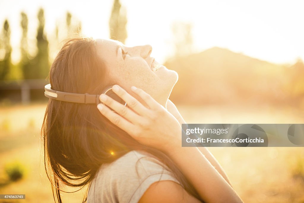 Young happy woman with ear phone