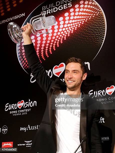 Sweden's Mans Zelmerlow holds up the trophy during the press conference after winning the Eurovision Song Contest final early on May 24, 2015 in...