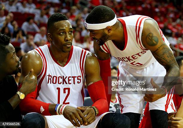 Josh Smith talks to Dwight Howard of the Houston Rockets on the bench in the fourth quarter against the Golden State Warriors during Game Three of...