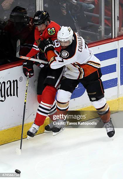 Andrew Cogliano of the Anaheim Ducks checks Kyle Cumiskey of the Chicago Blackhawks in overtime during Game Four of the Western Conference Finals...