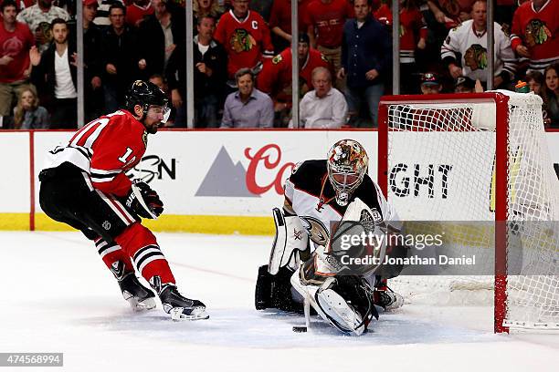 Frederik Andersen of the Anaheim Ducks makes a save against Patrick Sharp of the Chicago Blackhawks in the first overtime period of Game Four of the...