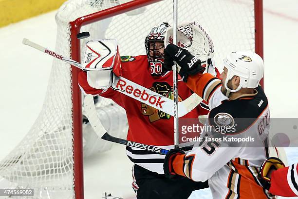 Ryan Getzlaf of the Anaheim Ducks tries to deflect the puck against Corey Crawford of the Chicago Blackhawks in the first overtime period of Game...