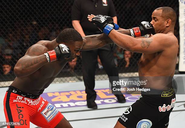 Anthony Johnson punches Daniel Cormier in their UFC light heavyweight championship bout during the UFC 187 event at the MGM Grand Garden Arena on May...