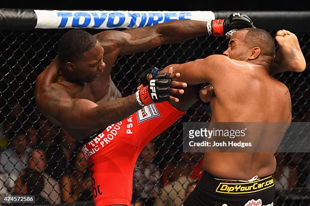 Anthony Johnson kicks Daniel Cormier in their UFC light heavyweight championship bout during the UFC 187 event at the MGM Grand Garden Arena on May...