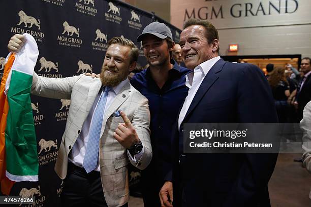 Conor McGregor, Patrick Schwarzenegger and Arnold Schwarzenegger backstage during the UFC 187 event at the MGM Grand Garden Arena on May 23, 2015 in...