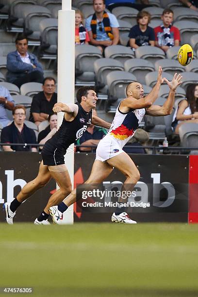 James Podsiadly of the Crows marks the ball against Michael Jamison of the Blues during the round three AFL NAB Challenge match between the Carlton...