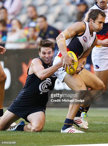 Dale Thomas of the Blues tackles Jason Porplyzia of the Crows during the round three AFL NAB Challenge match between the Carlton Blues and the...