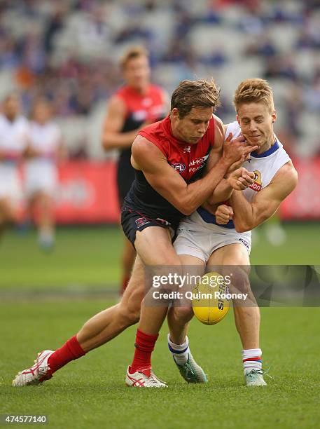 Rohan Bail of the Demons bumps Lachie Hunter of the Bulldogs during the round eight AFL match between the Melbourne Demons and the Western Bulldogs...