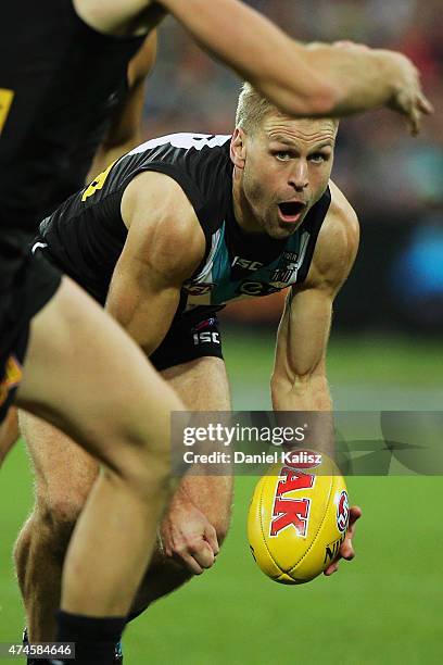 Kane Cornes of the Power handballs during the round eight AFL match between the Port Adelaide Power and the Richmond Tigers at Adelaide Oval on May...