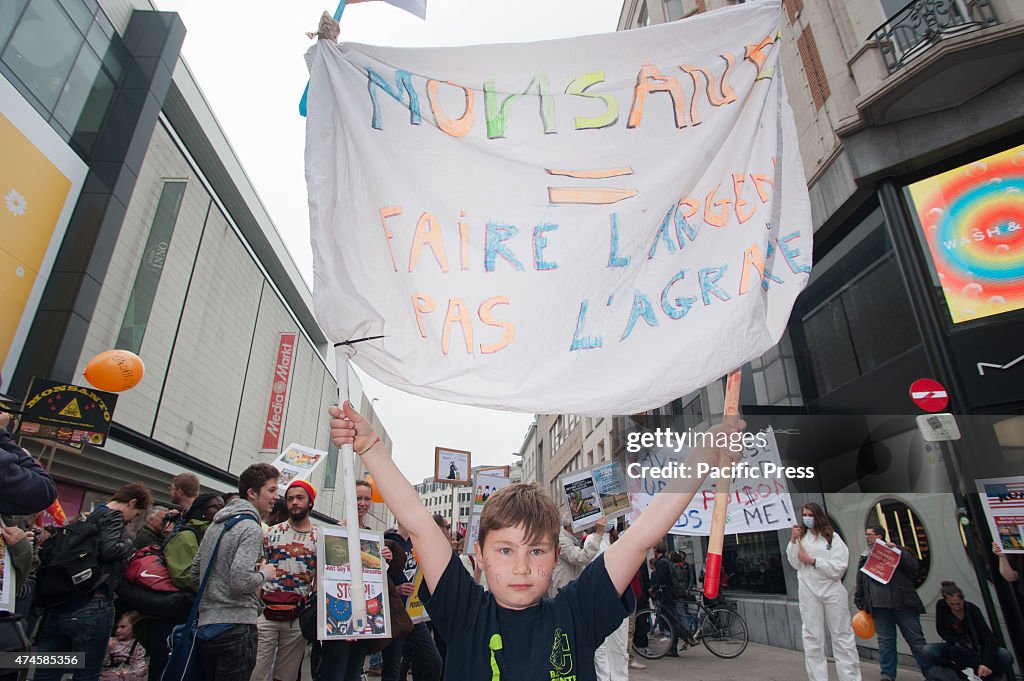 A child holding a sign at the march against Monsanto in...