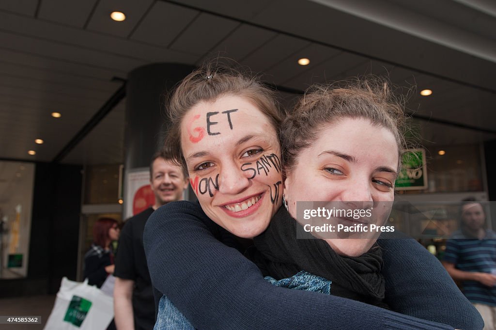 Two girls hugging with the text ' get Monsanto out' written...