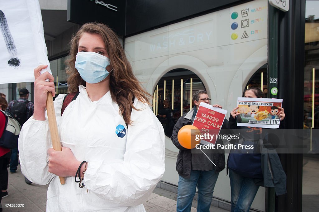 A protester with a breathing mask covering her face stands...