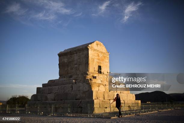 An Iranian woman poses for a picture on May 19 in front of the tomb of Cyrus II of Persia, known as Cyrus the Great, the founder of the Persian...
