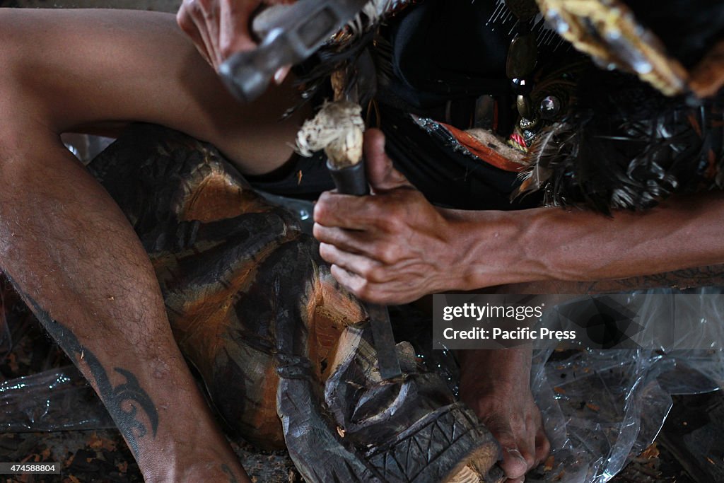 The craftsman of Dayak competing to curve and paint shields...