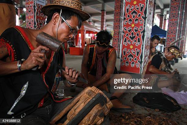 The craftsman of Dayak competing to curve and paint shields, using real wood material of Borneo's best quality called Belian, during the "Gawai Dayak...