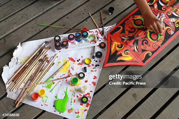 The craftsman of Dayak competing to curve and paint shields, using real wood material of Borneo's best quality called Belian, during the "Gawai Dayak...