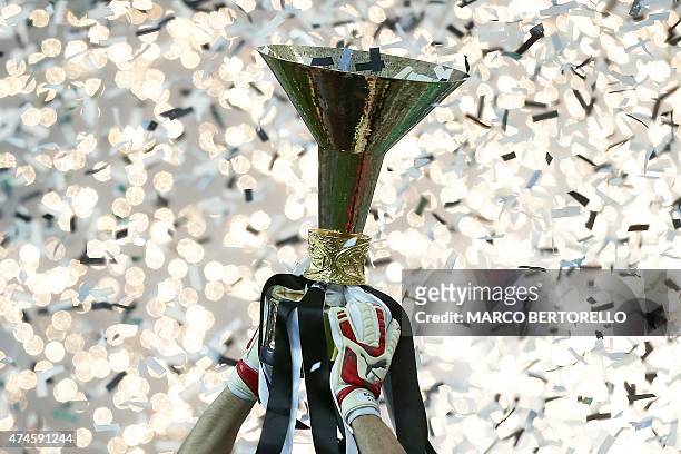 Juventus' goalkeeper and captain Gianluigi Buffon holds the Italian League's trophy during a ceremony following the Italian Serie A football match...