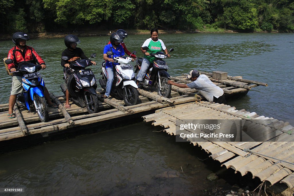 The crew pulls chartered traditional bamboo raft on the...