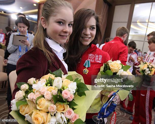 Russian Olympic gold medalists in figure skating Adelina Sotnikova and Yulia Lipnitskaya pose for the media during an awards ceremony for Russian...