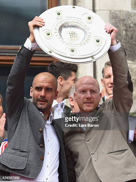 Head coach Josep Guardiola and manager Matthias Sammer lift the trophy and celebrate winning the Bundesliga at Marienplatz on May 24, 2015 in Munich,...